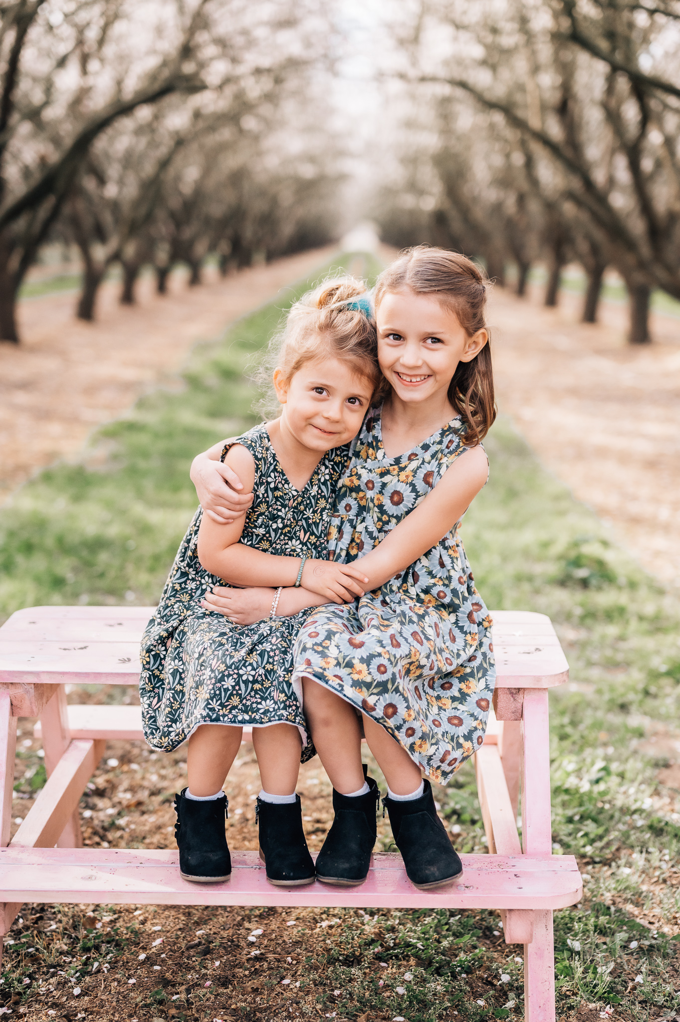 sisters in almond blossom orchard